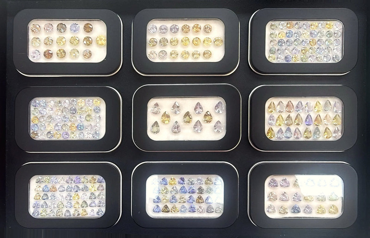 Tray of calibrated multicolour tanzanite in pastel yellow, peach, lavender and blue