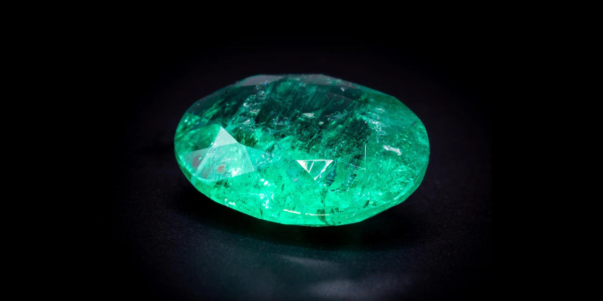 Untreated no-oil Colombian emerald, 1.82 ct oval, on a black background