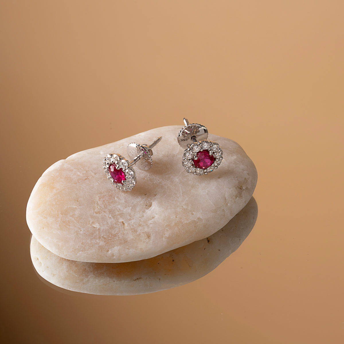 Ruby and diamond halo stud earrings in white gold on stacked stones