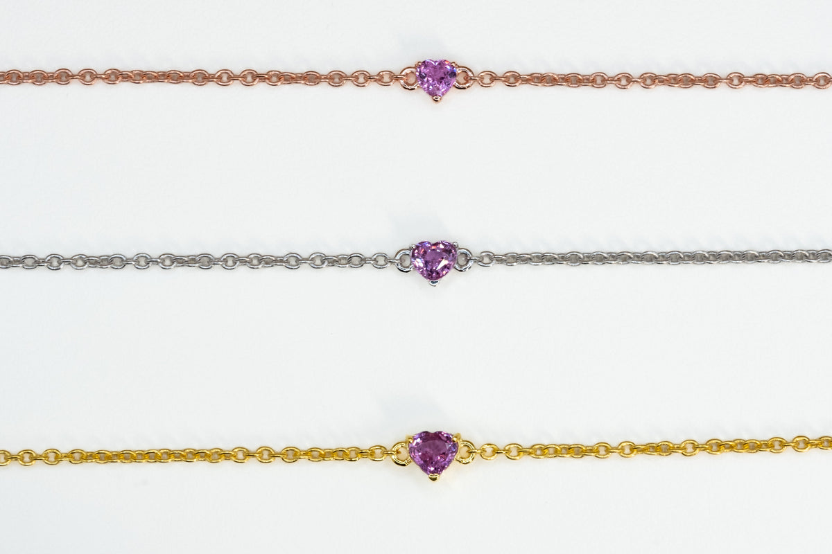 Three pink sapphire heart bracelets in yellow gold, rose gold and white rhodium plated 925 sterling silver
