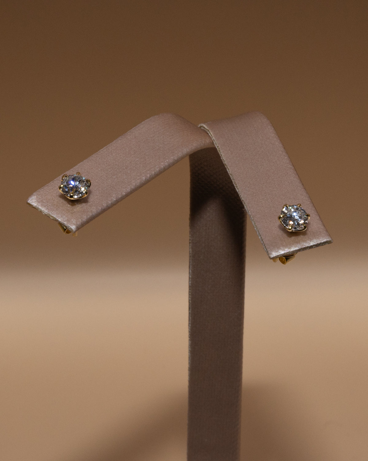 Lab-grown diamond studs on an earring stand