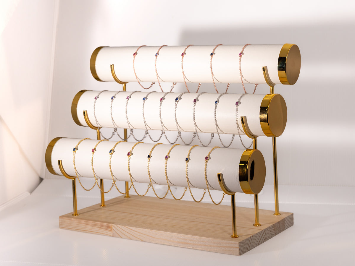 The Heart Drop: sapphire heart bracelets on a bracelet stand