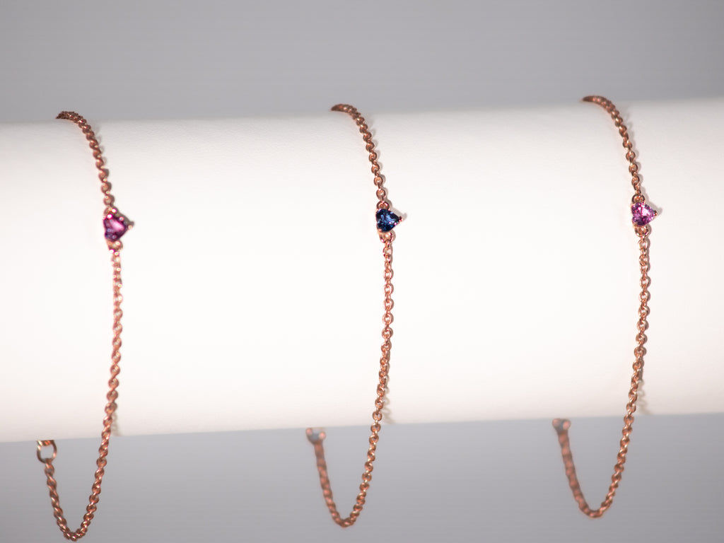 Rose gold plated sapphire heart bracelets on a display