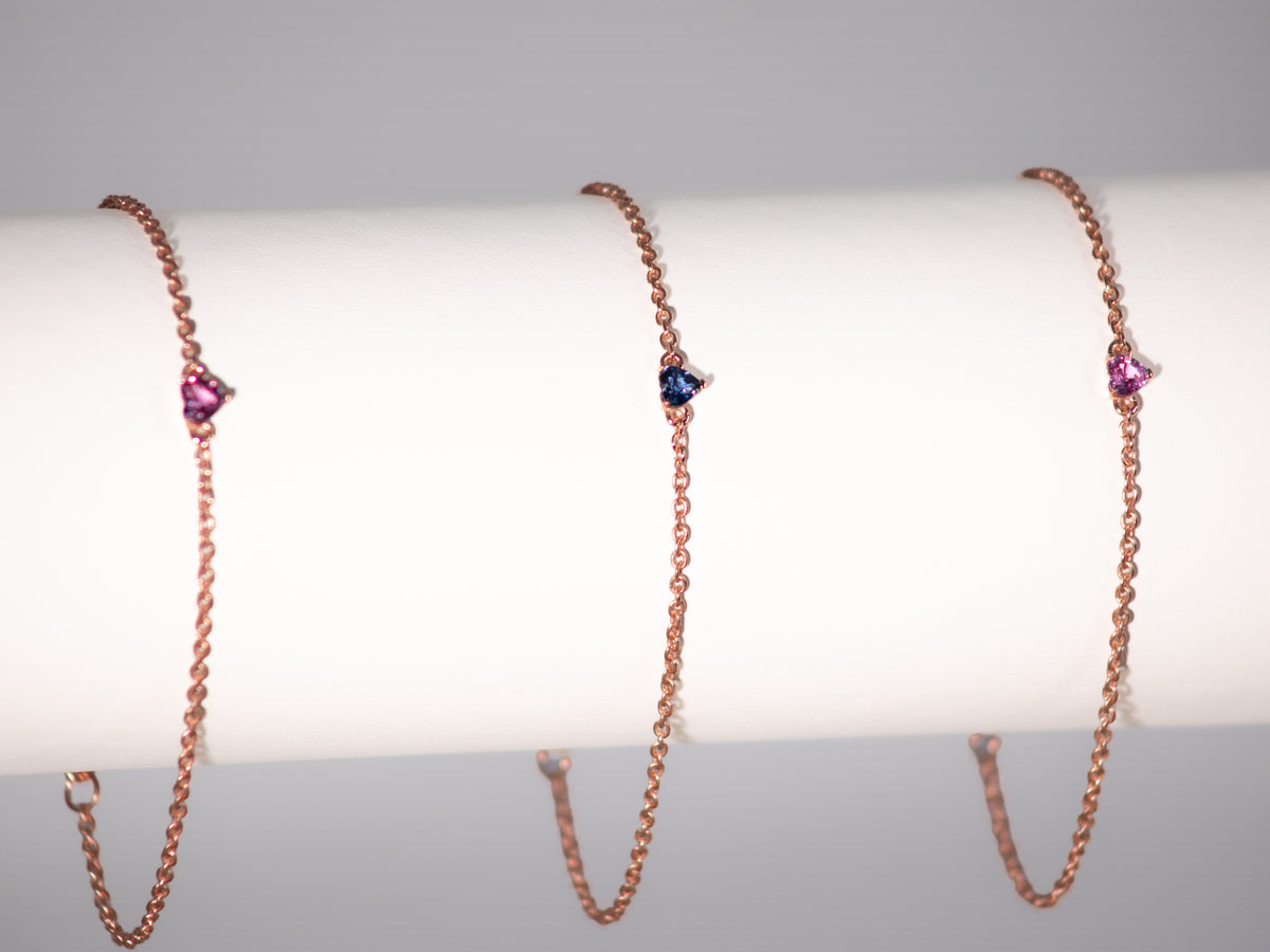 Rose gold plated sapphire heart bracelets on a display