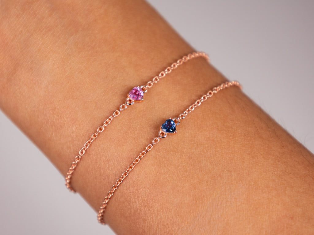 Pink and blue sapphire heart bracelets stacked on the wrist, rose gold plated 925 silver