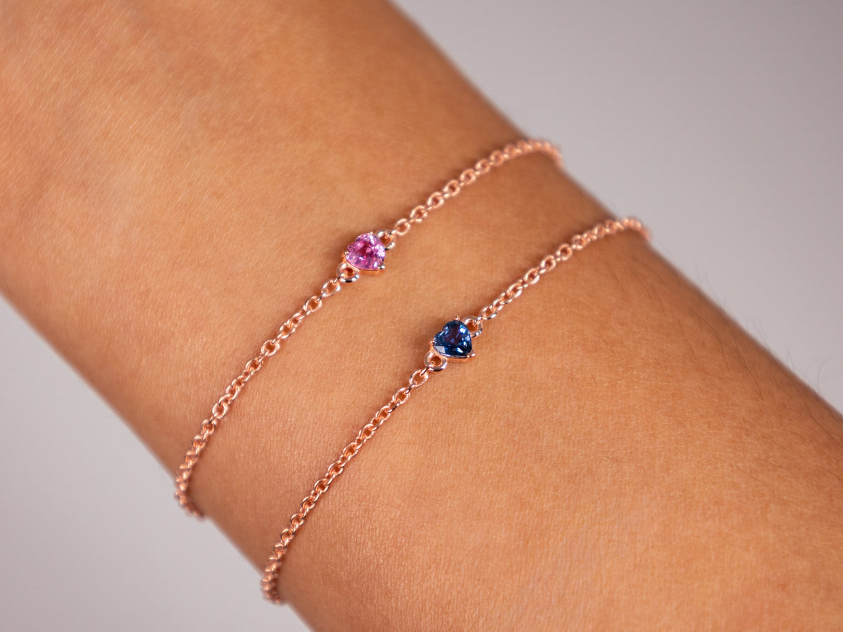 Pink and blue sapphire heart bracelets stacked on the wrist, rose gold plated 925 silver