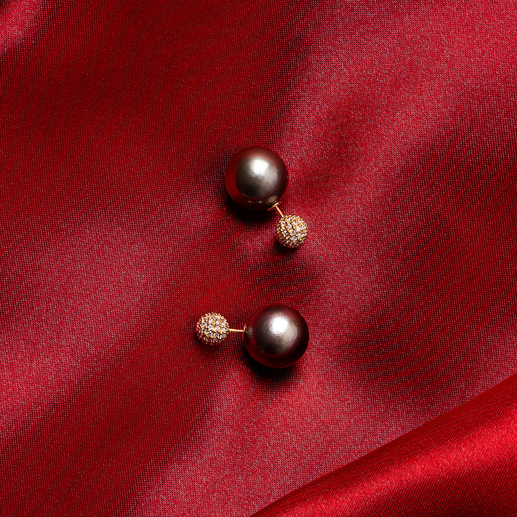 Pair of Tahitian pearl and diamond front-back earrings in 18K yellow gold on red silk