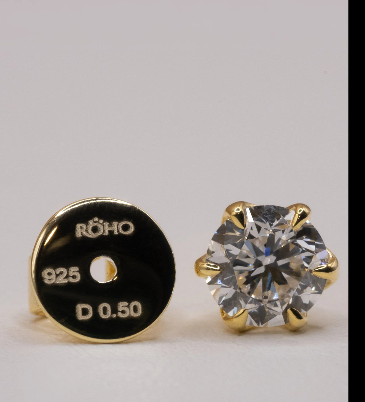 Earring back stamped ROHO 925 D 0.50 beside the yellow gold plated stud