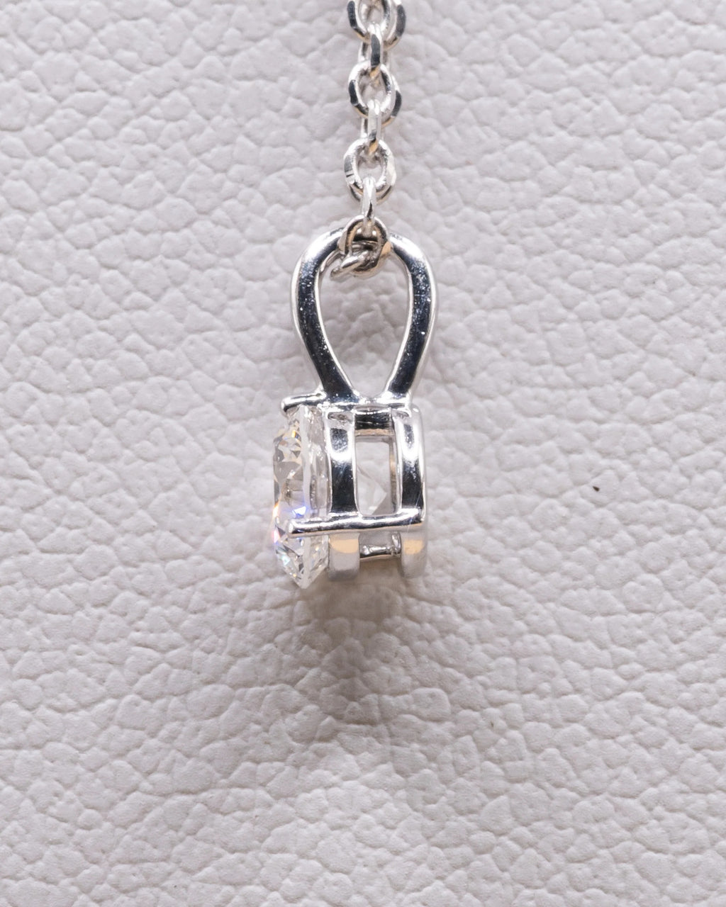 Side view of the white rhodium solitaire pendant and bail