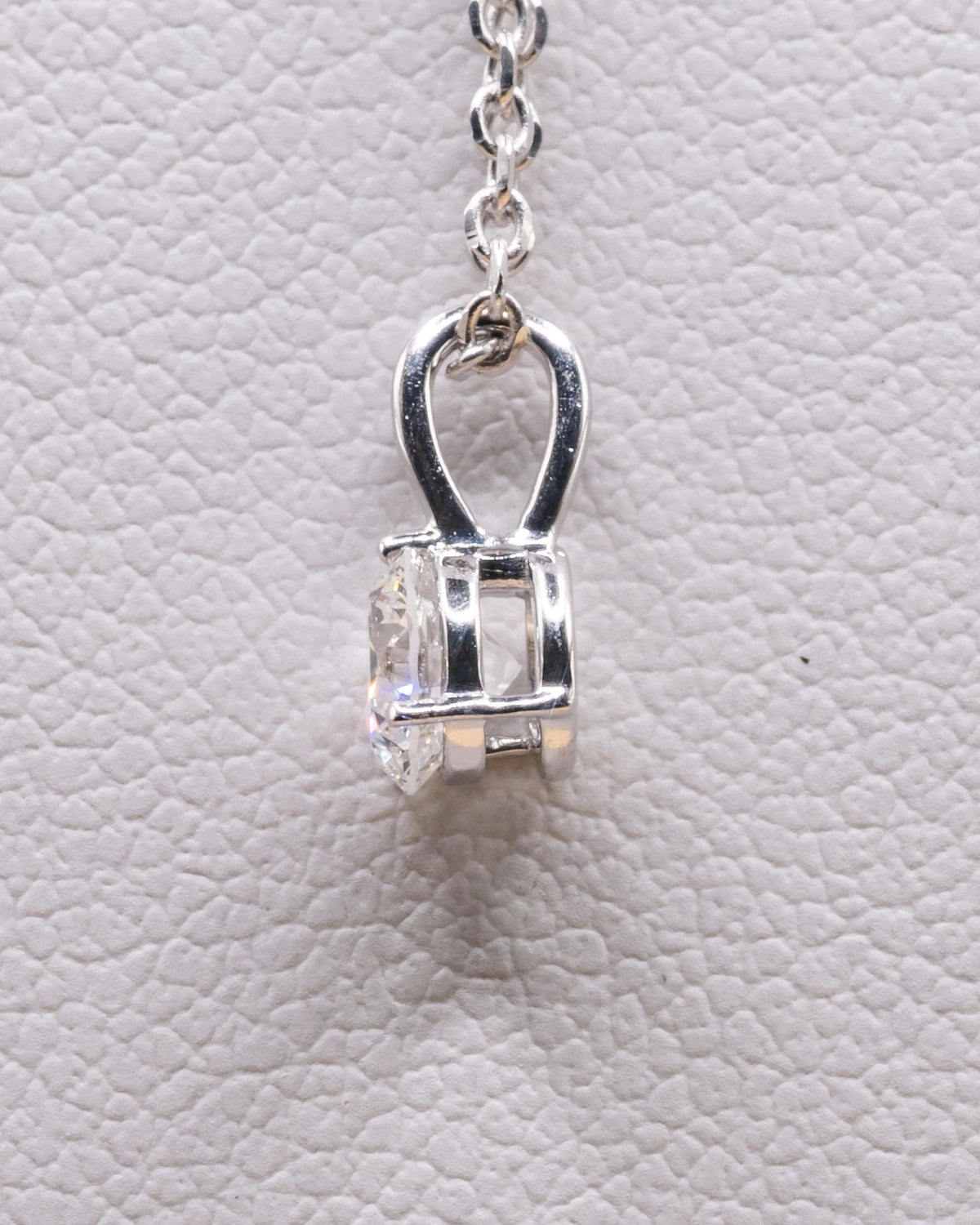 Side view of the white rhodium solitaire pendant and bail