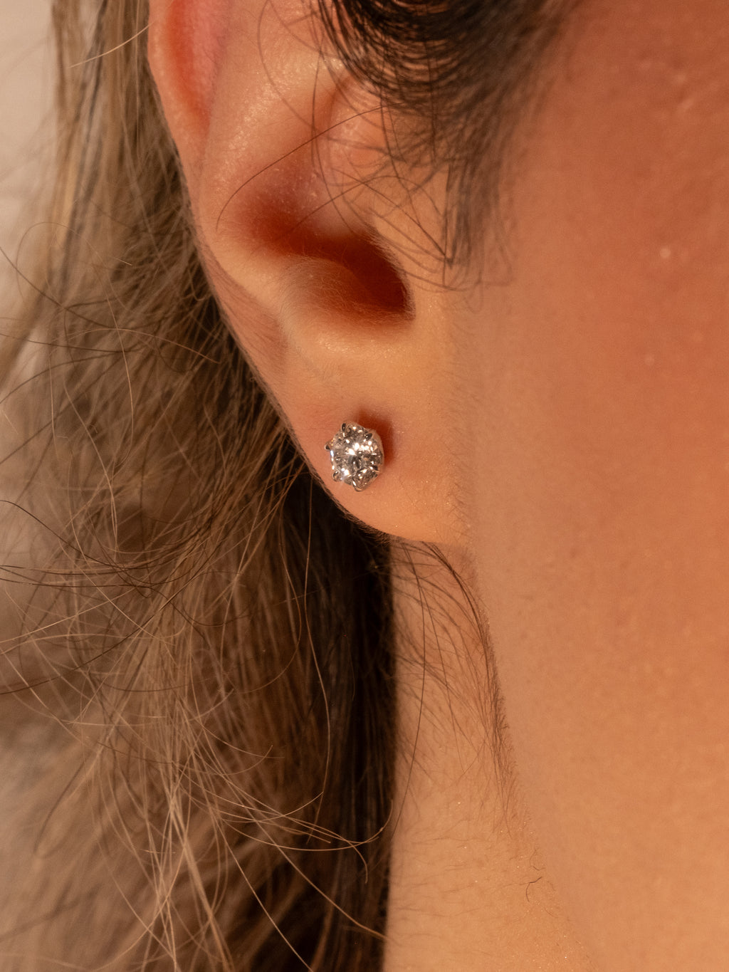 Lab-grown diamond stud earring on the ear, everyday size