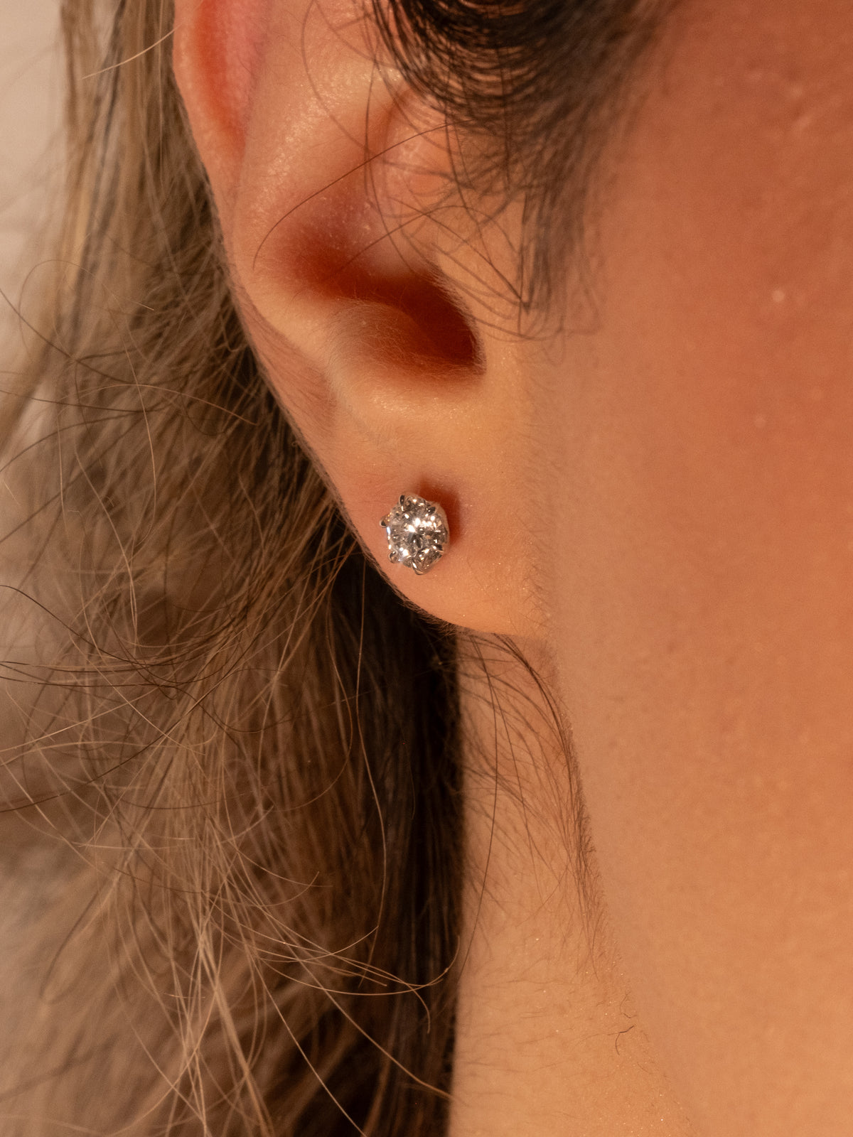 Lab-grown diamond stud earring on the ear, everyday size