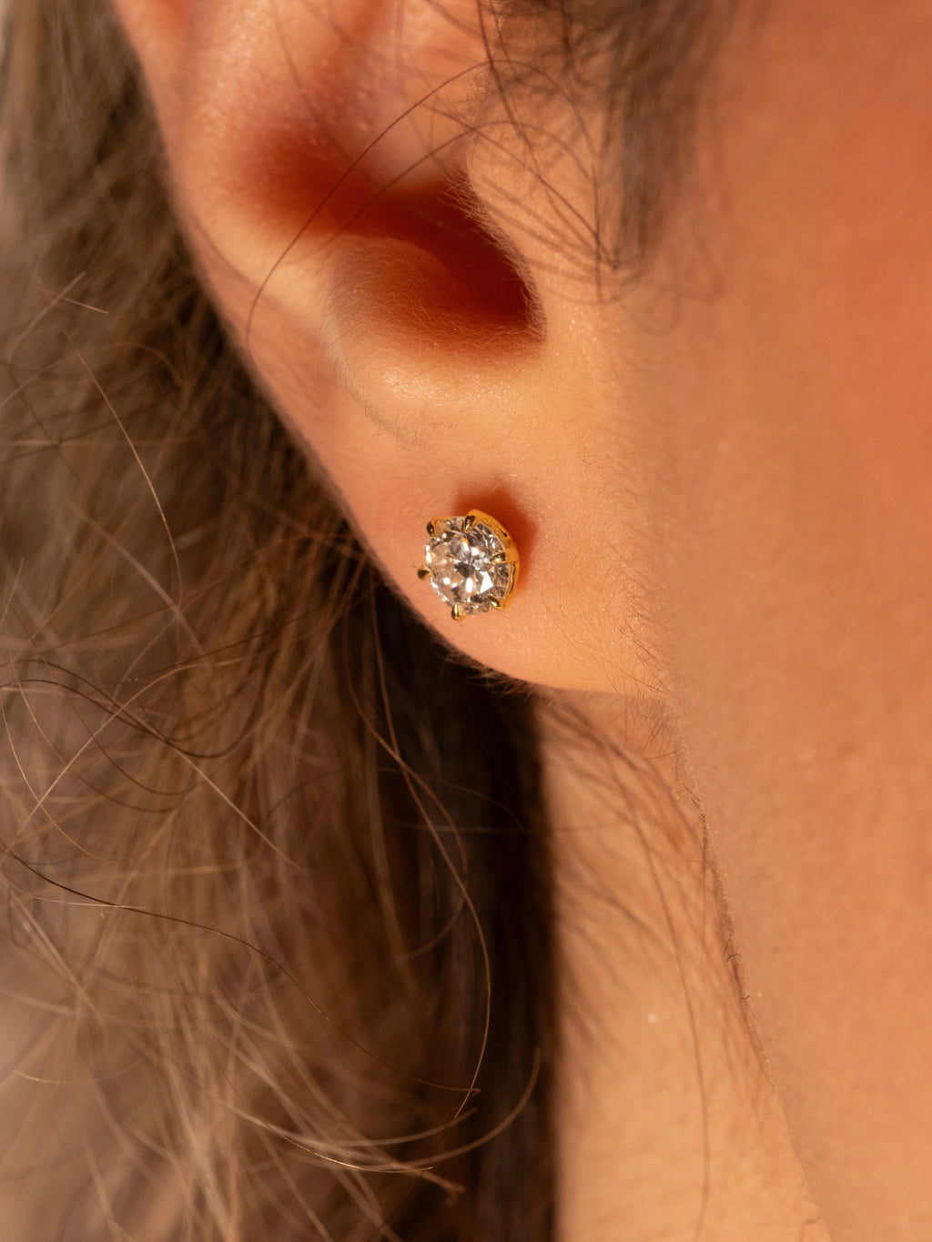 0.50 ct diamond stud in yellow gold plated silver worn on the ear