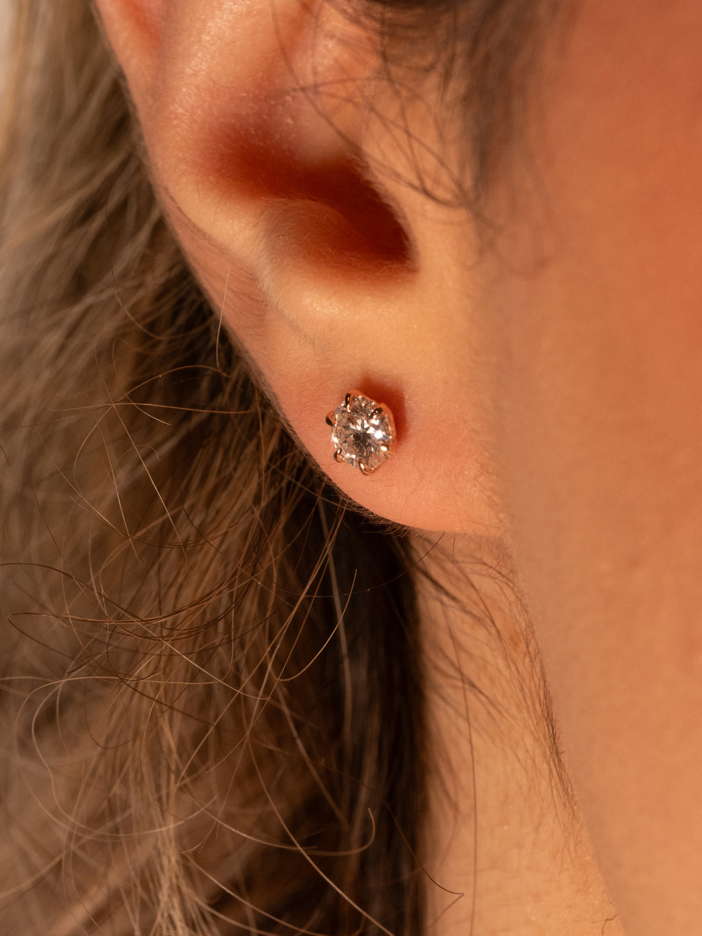 Lab-grown diamond stud on the ear, side profile