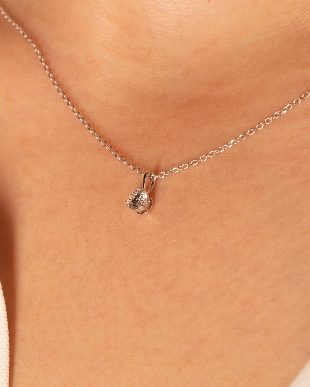 0.50 ct solitaire necklace in white rhodium plated 925 silver, worn