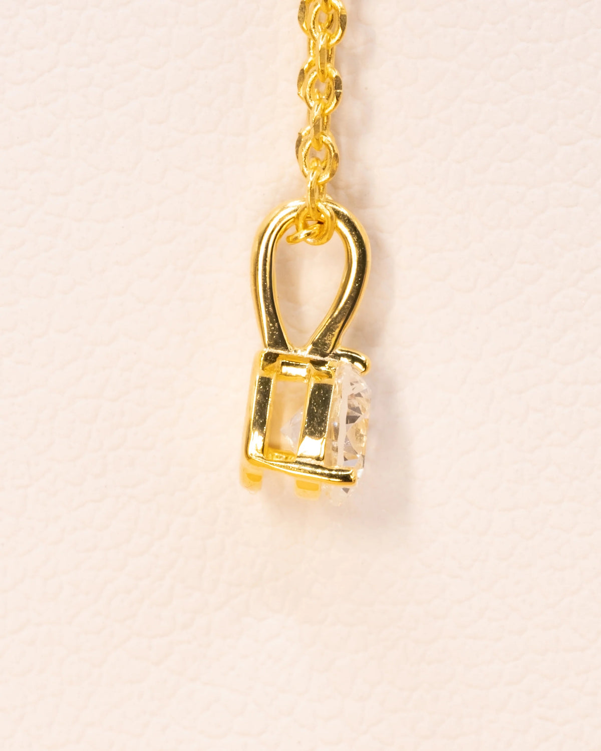 Side view of the yellow gold plated solitaire pendant and bail