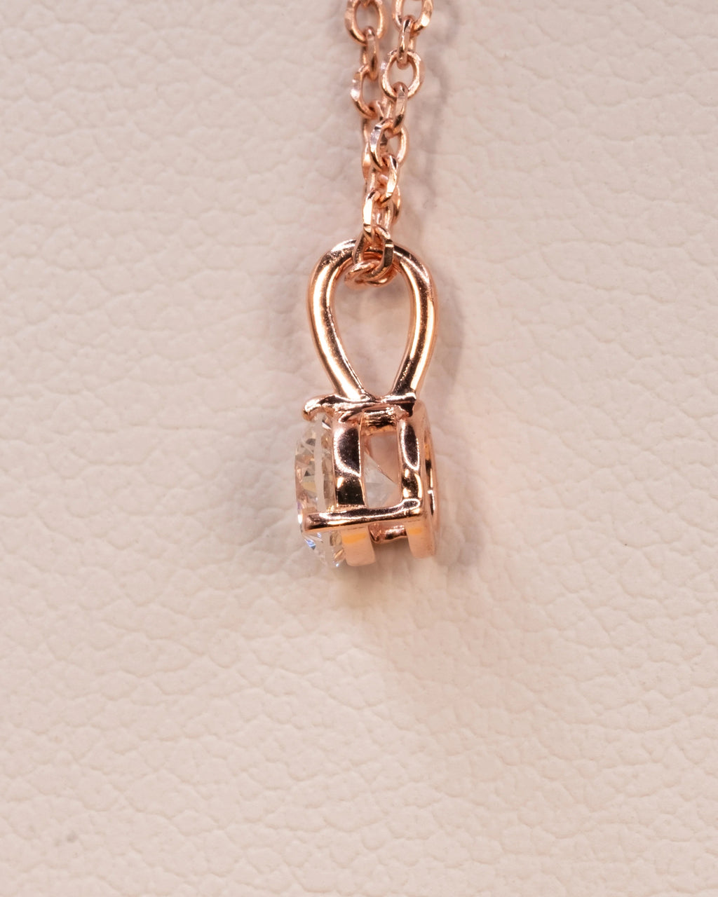 Side view of the rose gold plated solitaire pendant and bail