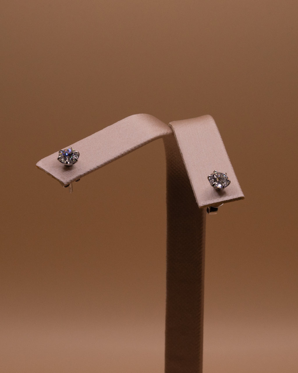 Lab-grown diamond studs, 1 ct total, on an earring stand