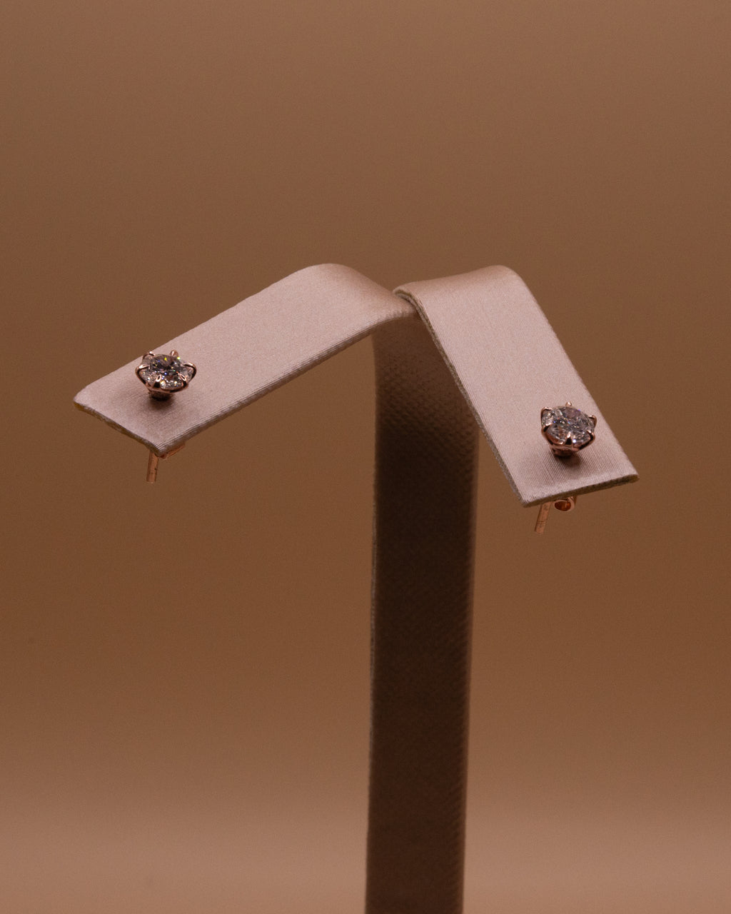 Pair of lab-grown diamond studs on an earring stand