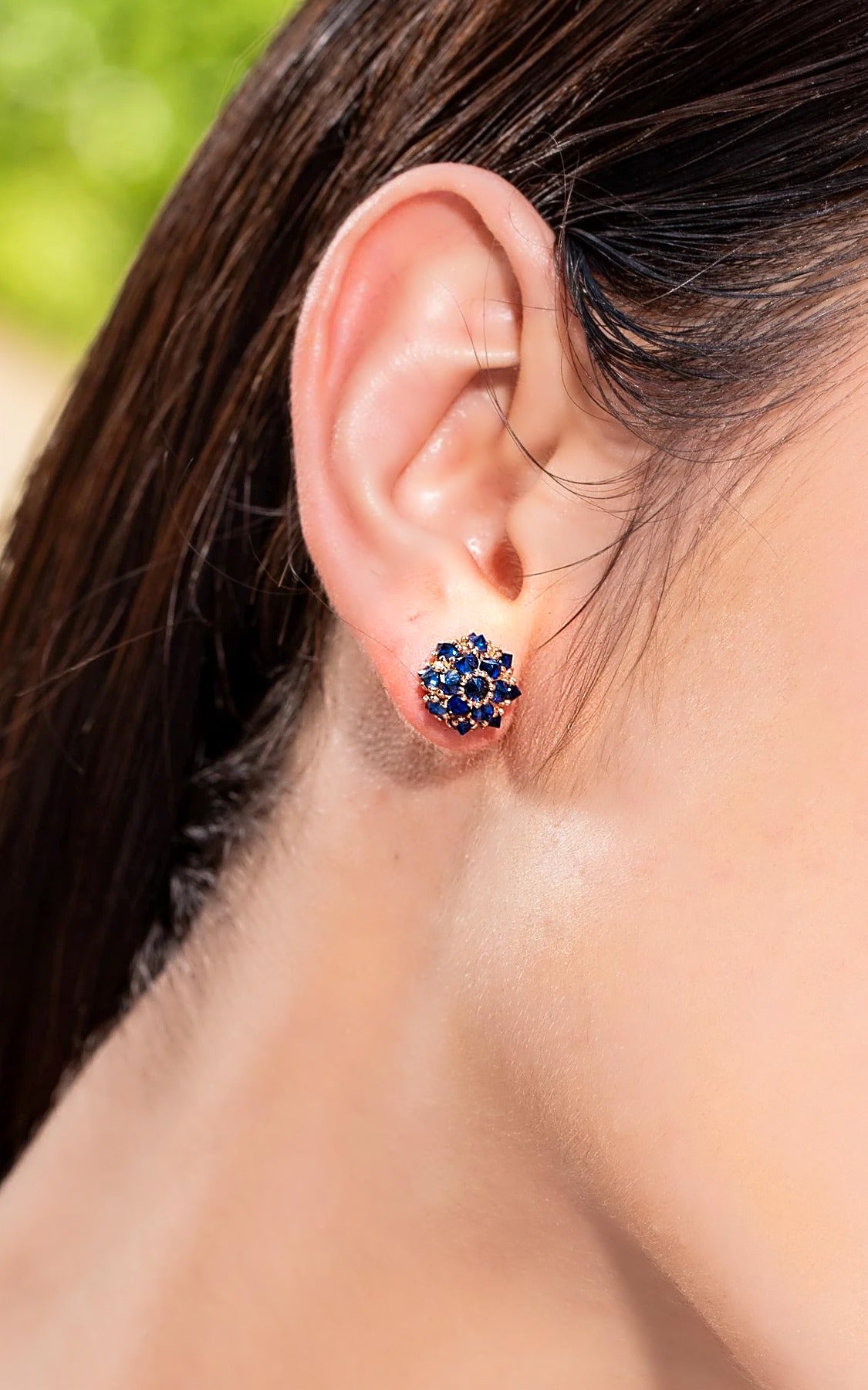 Blue sapphire spike ball stud earring in 18K gold, worn on the ear