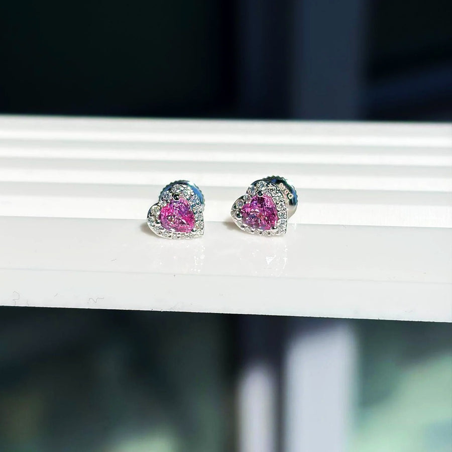 Small pink sapphire and diamond heart stud earrings in 18K white gold on a white display stand, photo 3 of 8