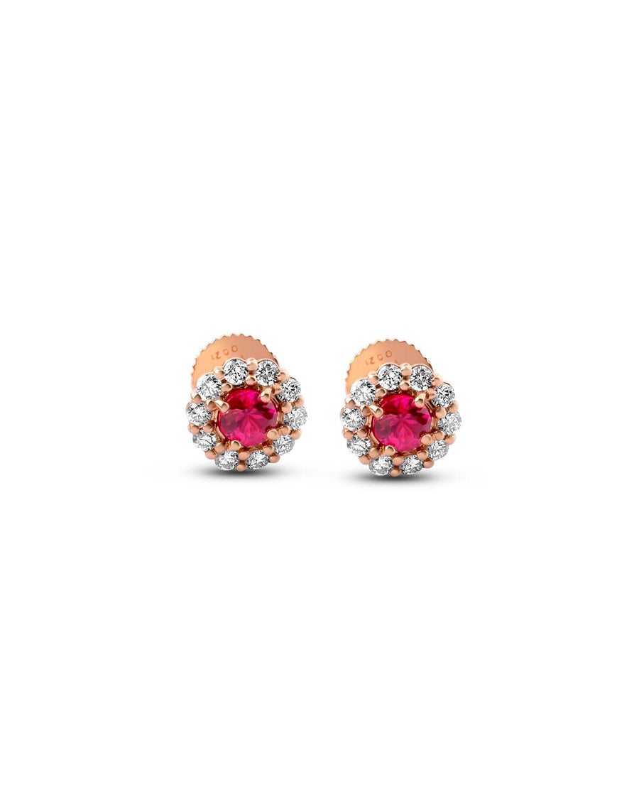 Front view of the ruby and diamond halo studs in 18K rose gold on white