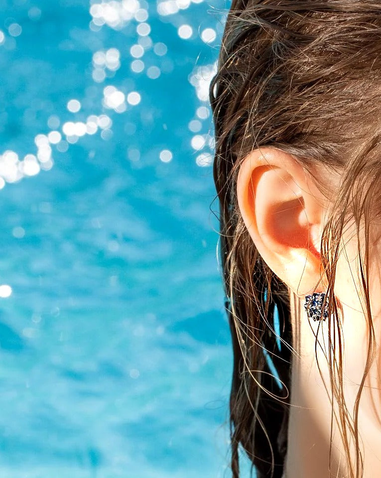 Blue sapphire spike ball stud earring in 18K gold, worn on the ear