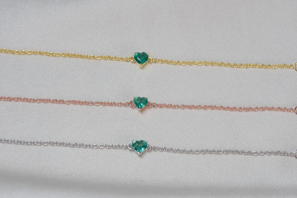 Natural emerald heart bracelet shown in yellow gold, rose gold and silver tone finishes