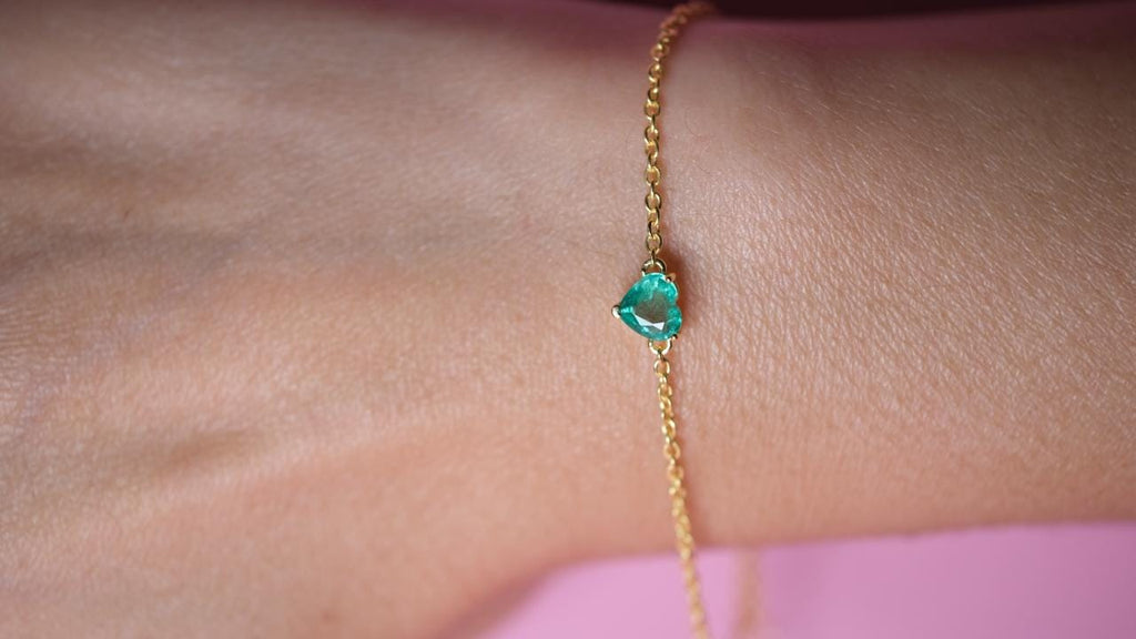 Yellow gold plated emerald heart bracelet on a fine polished cable chain