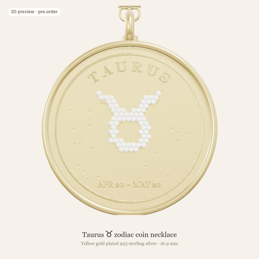 Front of the Taurus zodiac coin pendant in yellow gold plated 925 silver, with the Taurus glyph in lab-grown diamonds