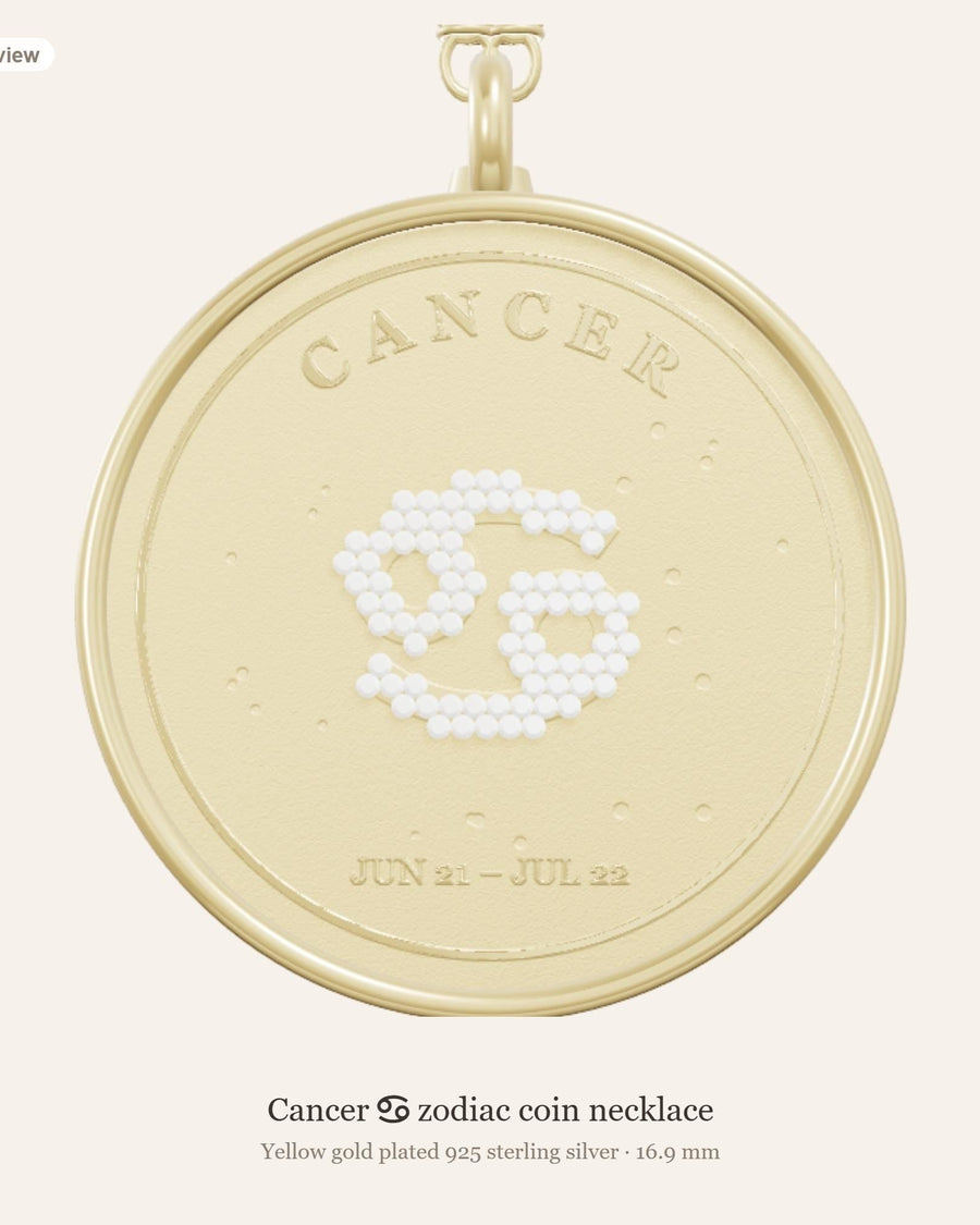 Front of the Cancer zodiac coin pendant in yellow gold plated 925 silver, with the Cancer glyph in lab-grown diamonds