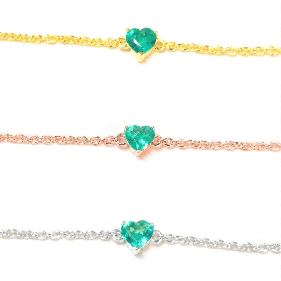 Natural emerald heart bracelets in yellow gold, rose gold and white rhodium plated 925 sterling silver, each with a 5mm heart-cut Zambian emerald