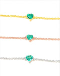 Natural emerald heart bracelets in yellow gold, rose gold and white rhodium plated 925 sterling silver, each with a 5mm heart-cut Zambian emerald