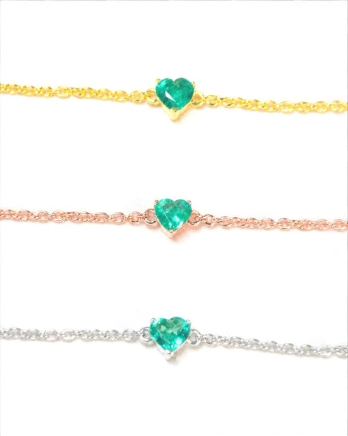 Natural emerald heart bracelets in yellow gold, rose gold and white rhodium plated 925 sterling silver, each with a 5mm heart-cut Zambian emerald