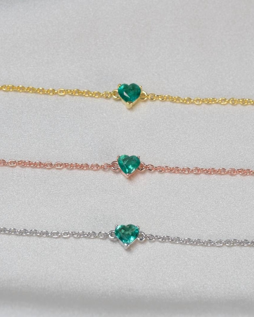 Natural emerald heart bracelet shown in yellow gold, rose gold and silver tone finishes